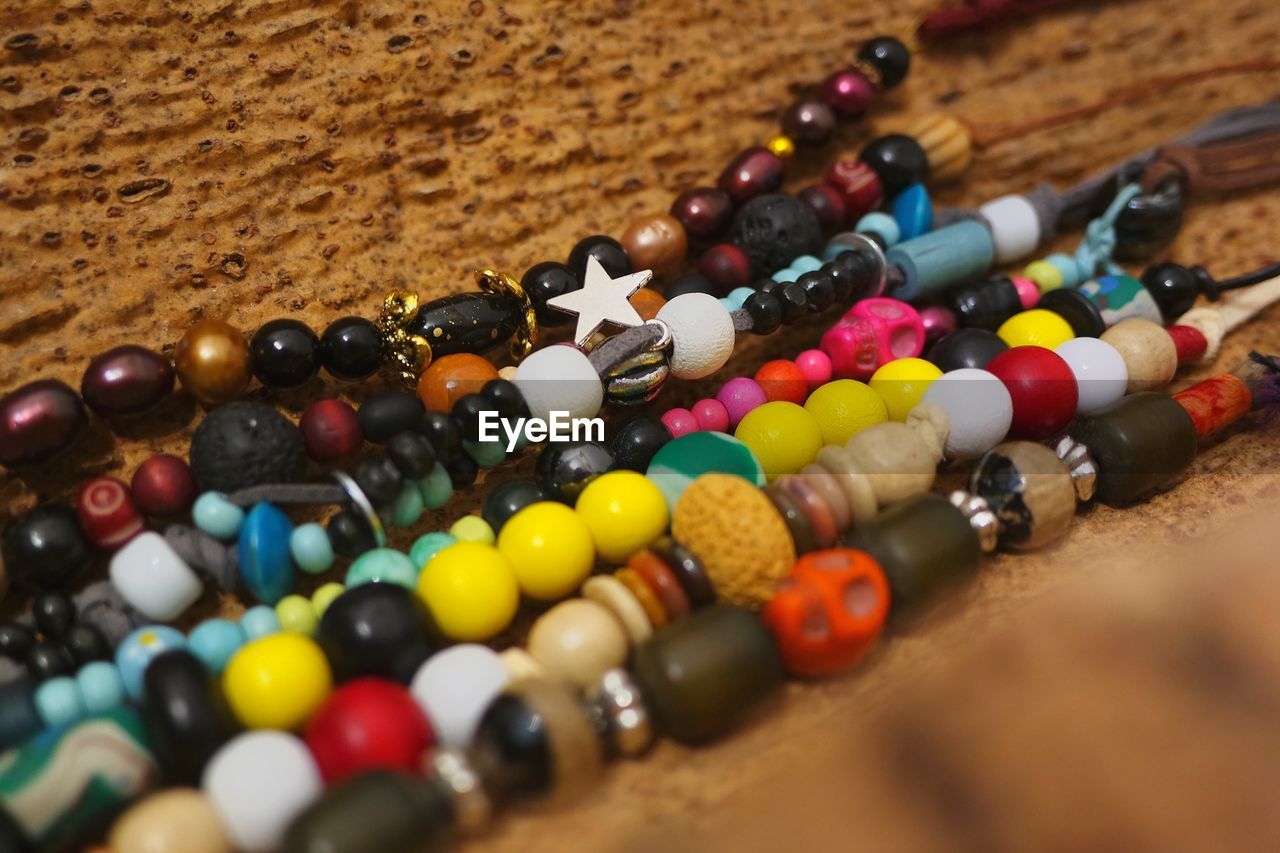 CLOSE-UP OF MULTI COLORED CANDIES ON TABLE
