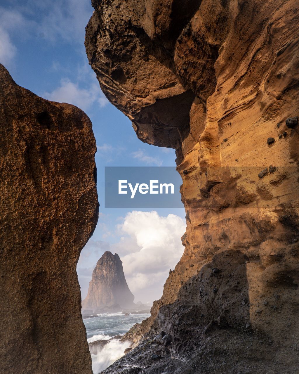 Rock formations in sea against sky