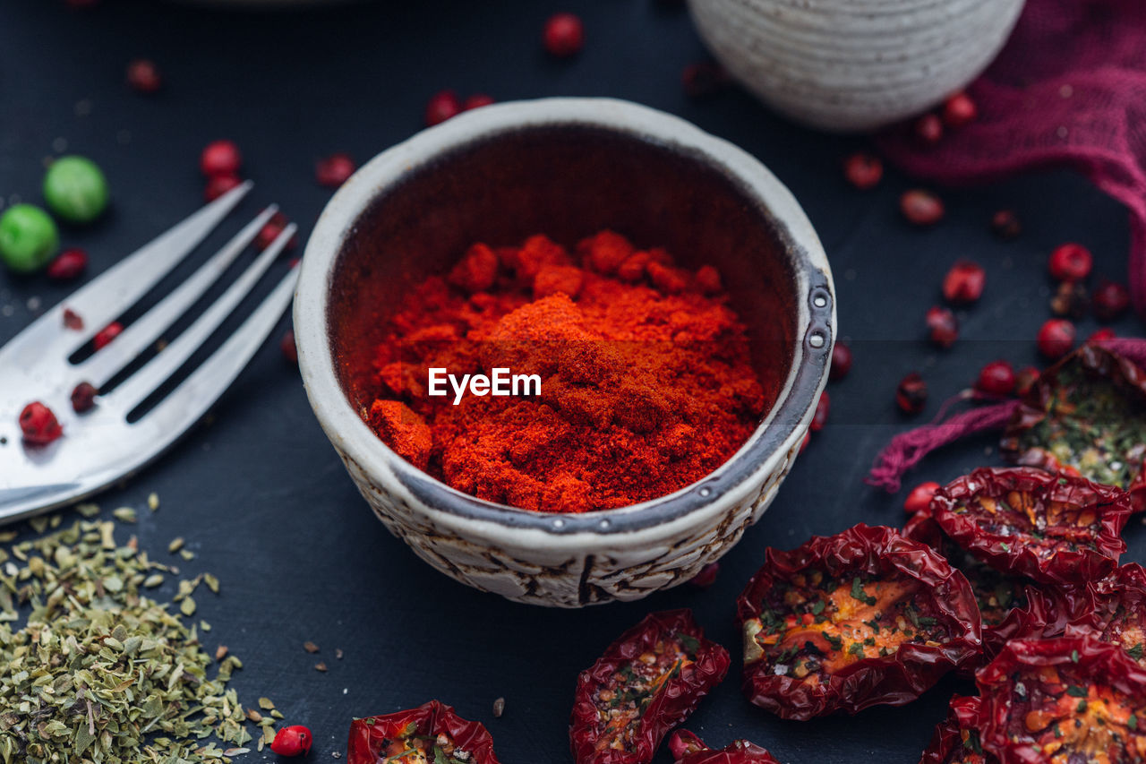 CLOSE-UP OF RED CHILI PEPPERS ON TABLE