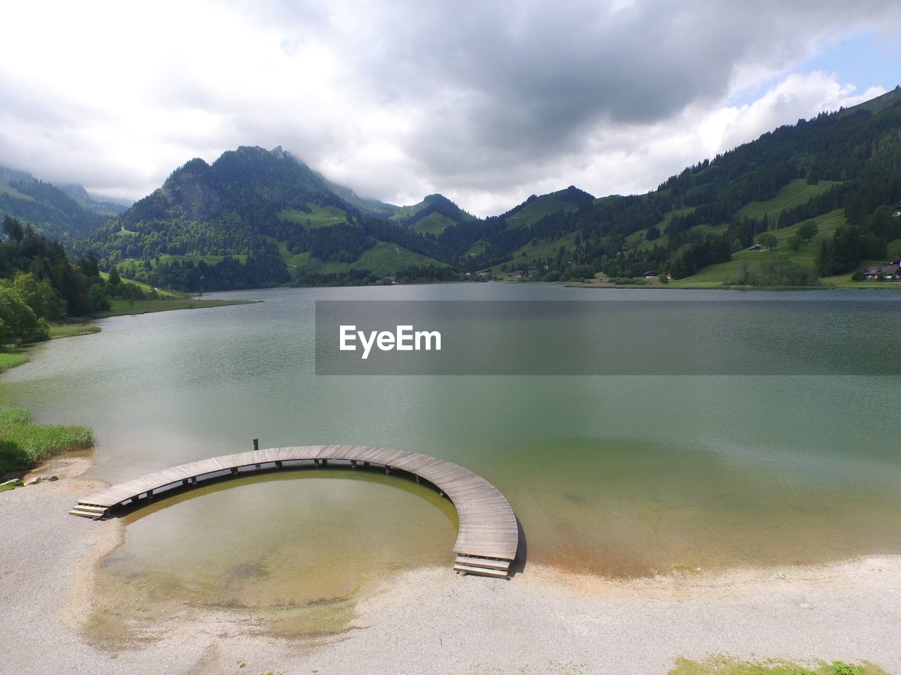 View of calm sea against mountain range