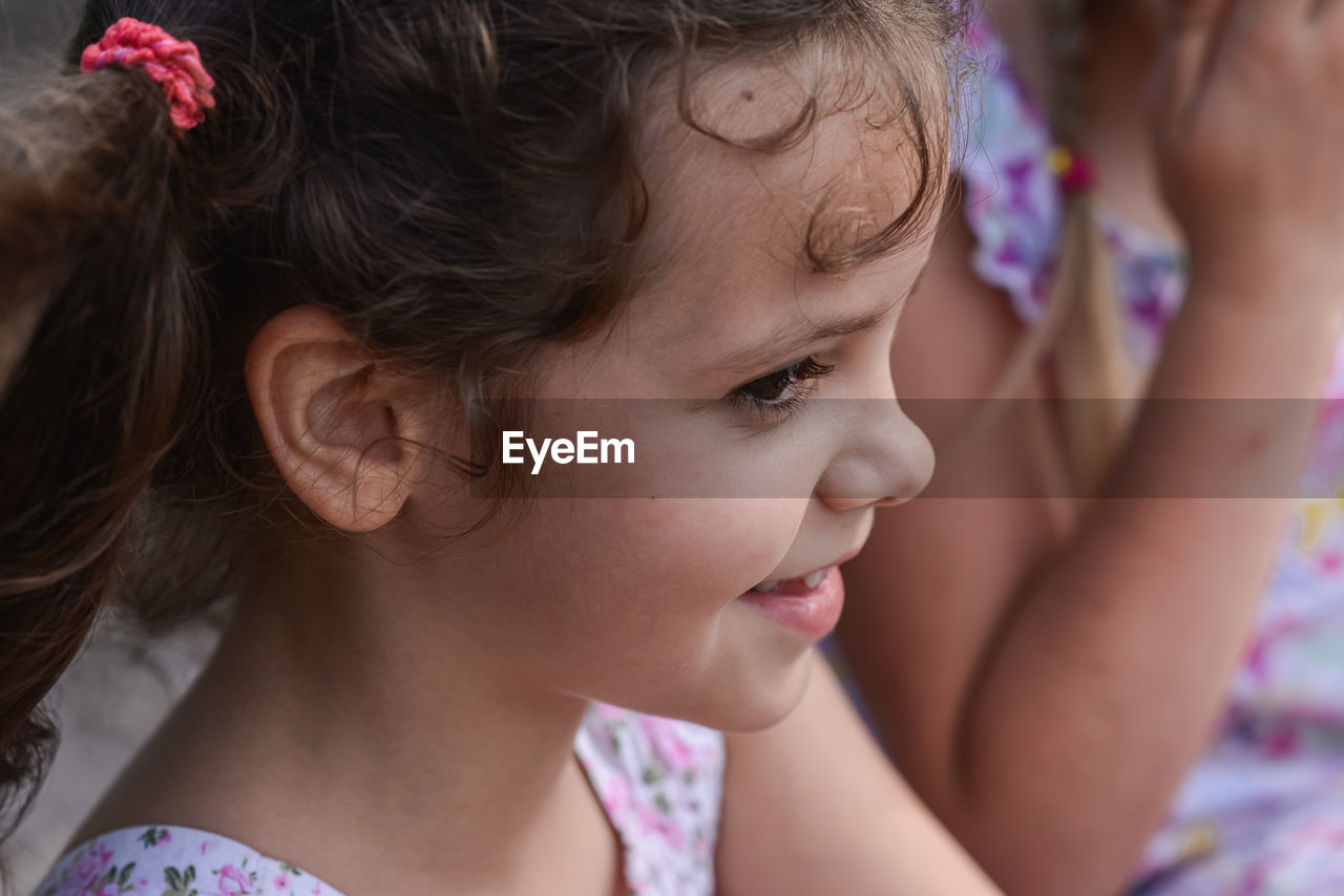 Close-up of cute girl looking away