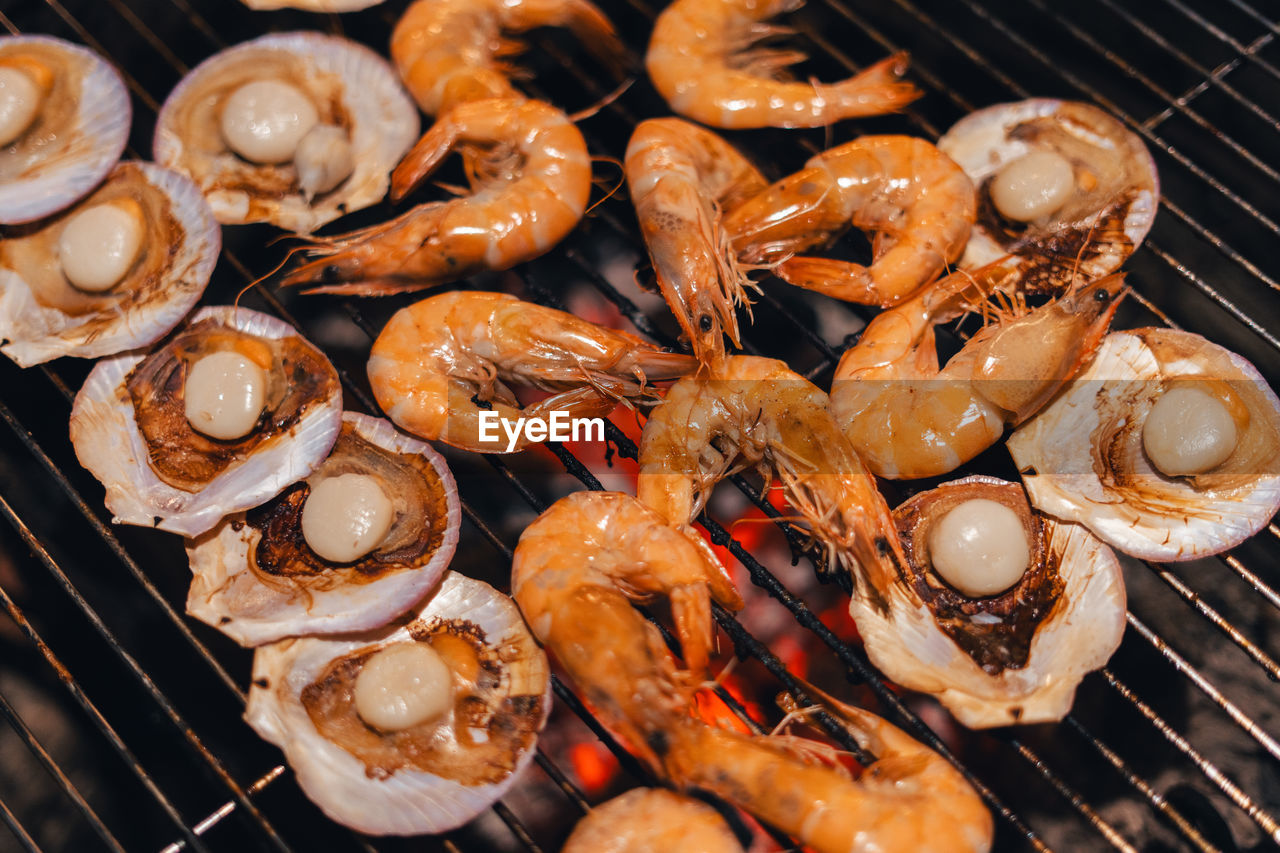 high angle view of meat cooking on barbecue grill