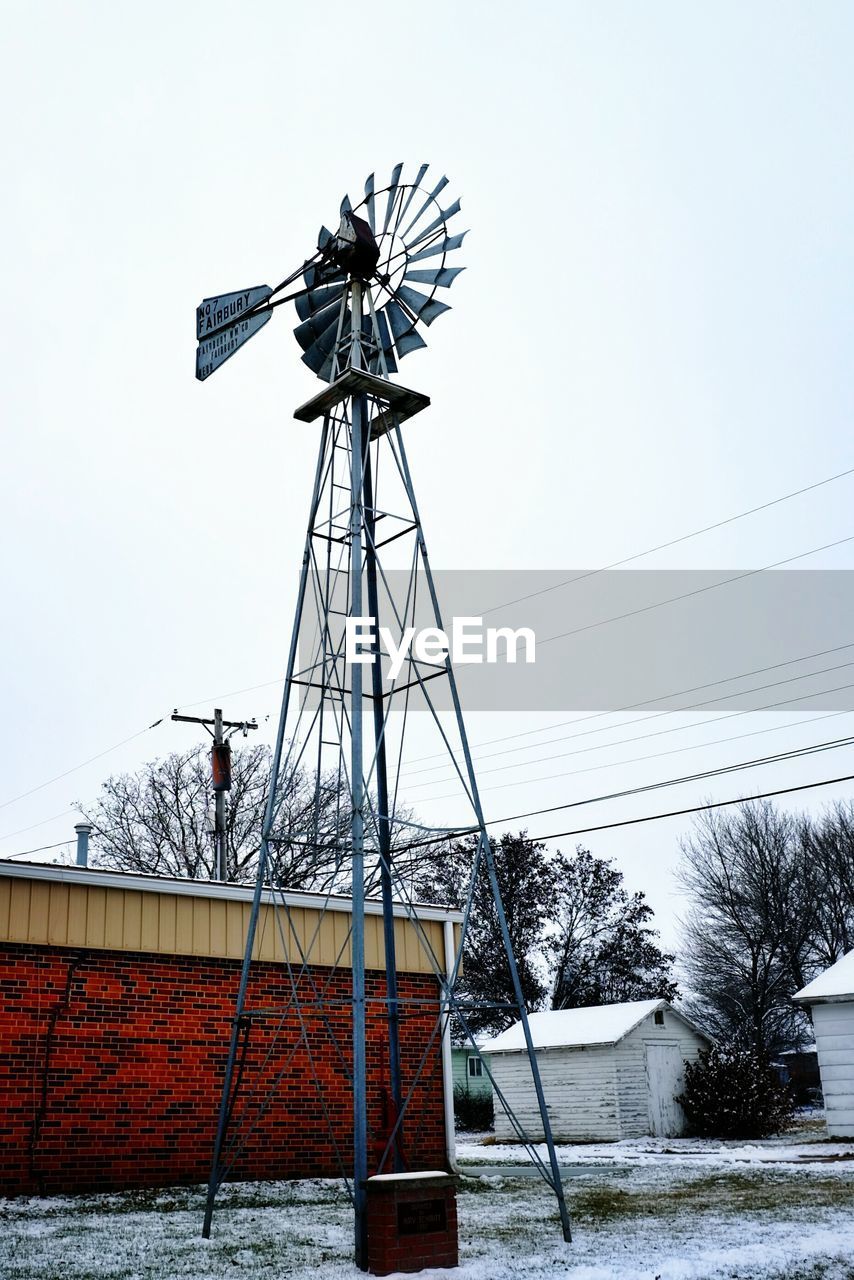 Low angle view of water pump windmill against clear sky