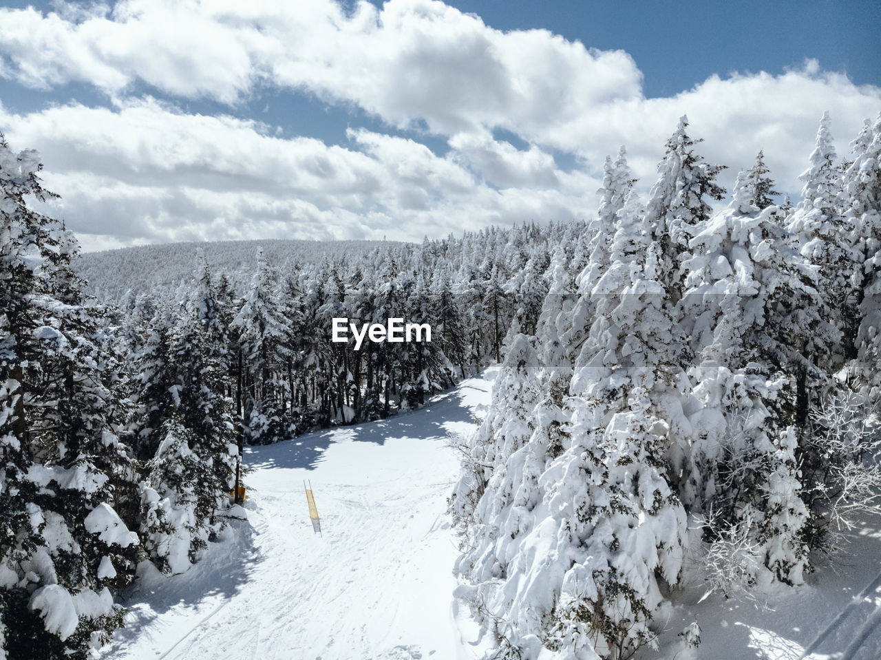 Snow covered landscape against sky