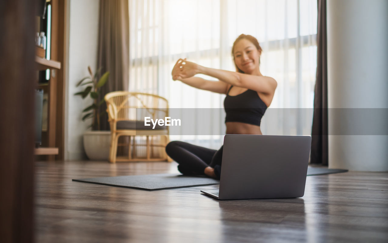 Young woman exercising in gym