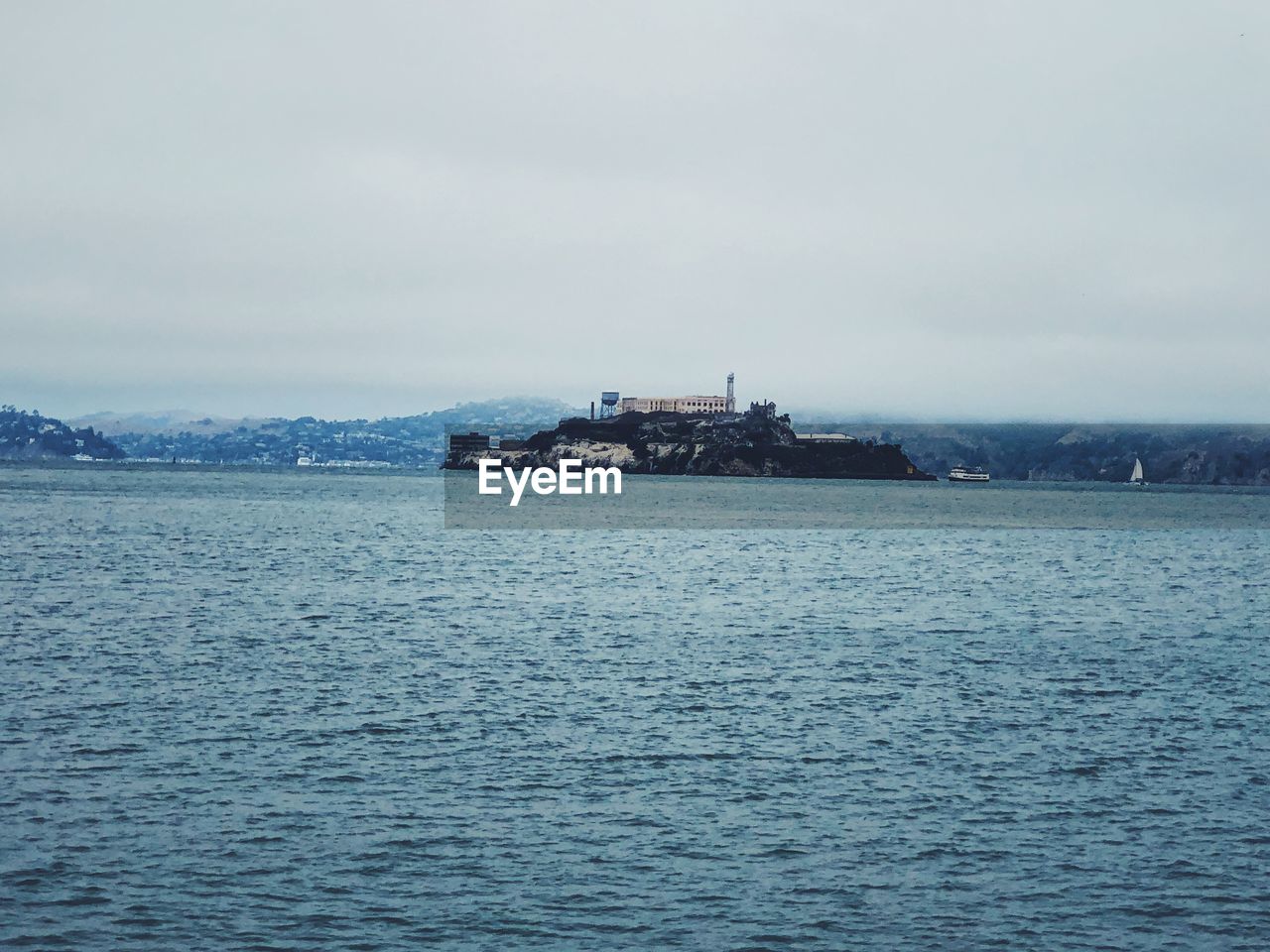 SCENIC VIEW OF SEA AGAINST BUILDINGS IN CITY