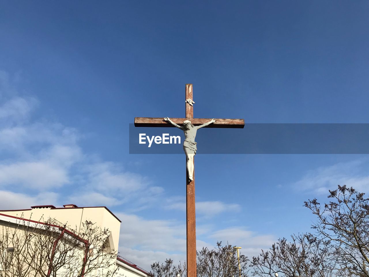 Low angle view of cross against blue sky