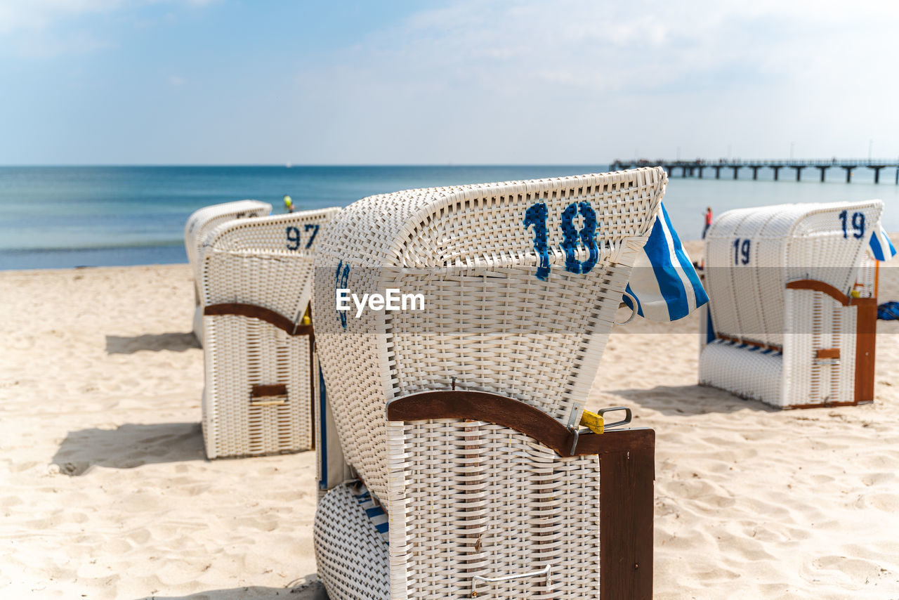 Beach chair on sand beach under blue sky and sunshine. german baltic sea beach scene.