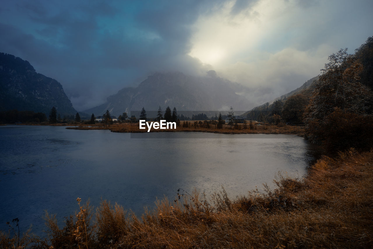 scenic view of lake by trees against sky