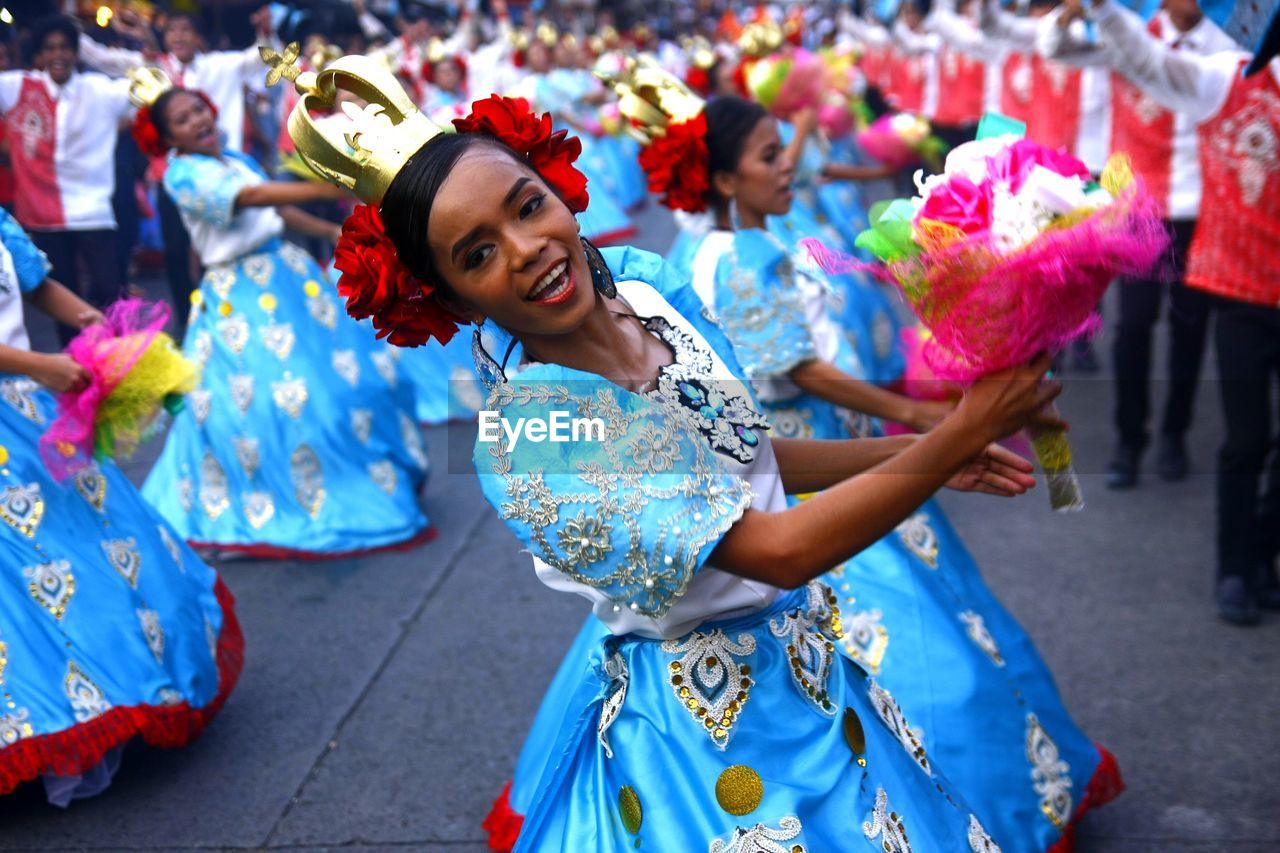 YOUNG WOMAN STANDING ON WALL DURING FESTIVAL