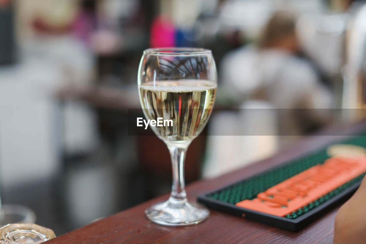 CLOSE-UP OF WINEGLASS ON TABLE