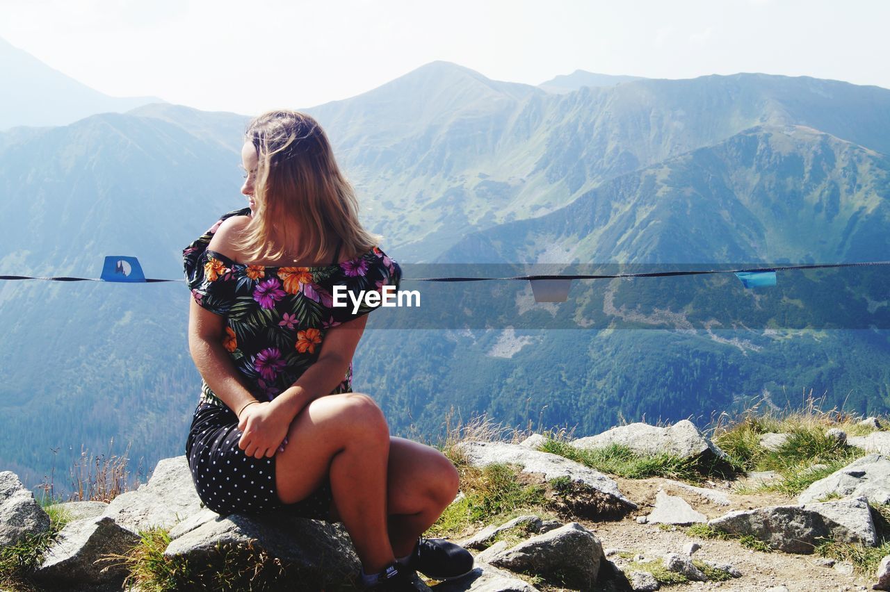 Woman sitting on mountain