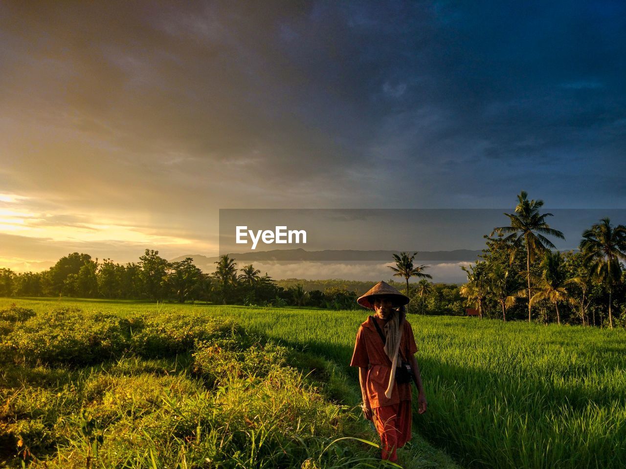 Person standing on field against sky