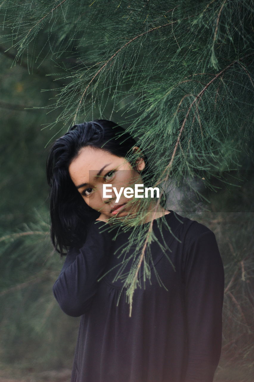 Portrait of young woman in forest