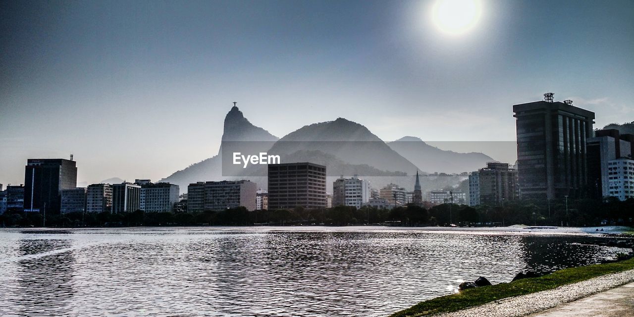 River with buildings against clear sky