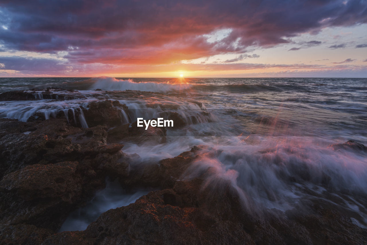 Scenic view of sea against sky during sunset