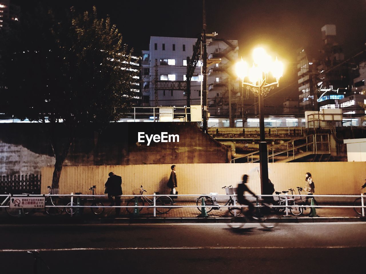 People on illuminated street at night