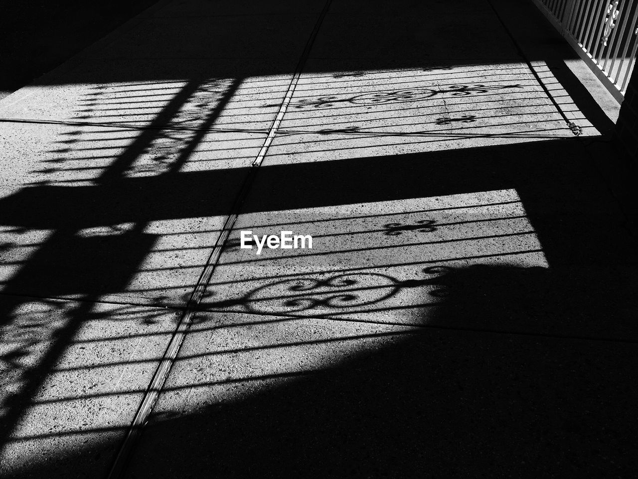 Shadow of fence on road