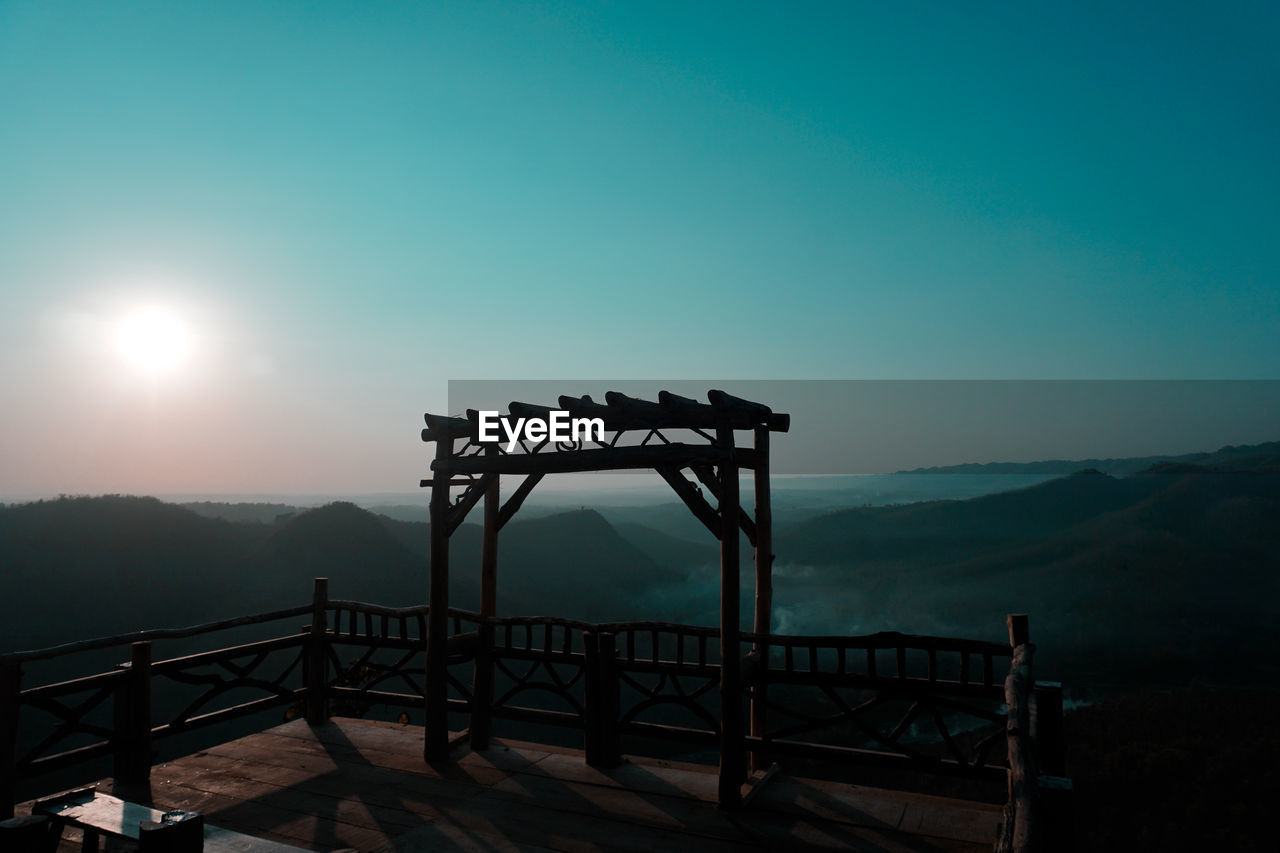 Gazebo on mountain against sky during sunset