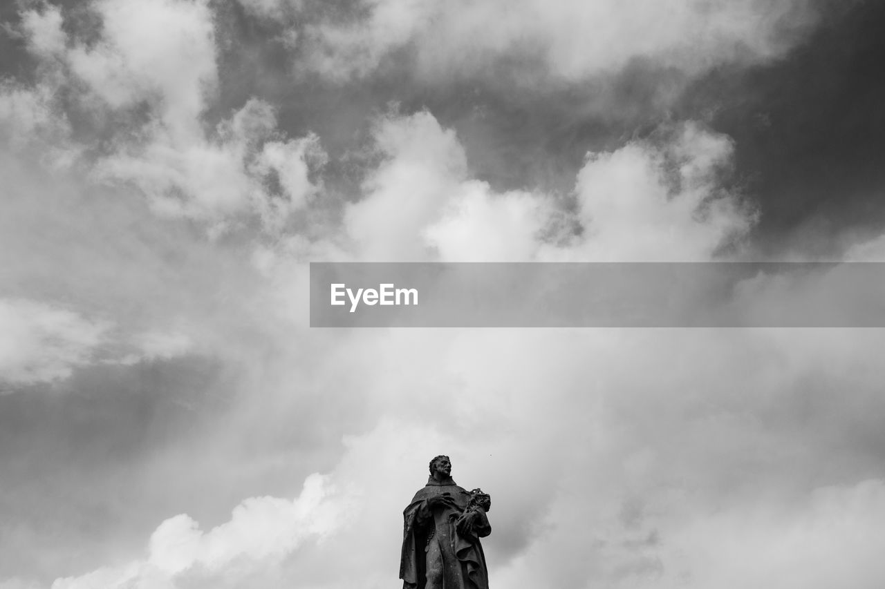 LOW ANGLE VIEW OF STATUE AGAINST CLOUDY SKY