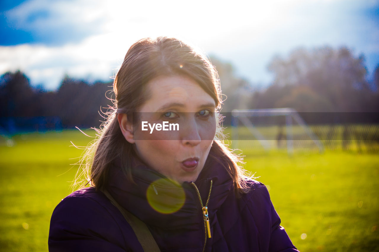 Portrait of woman standing on soccer field