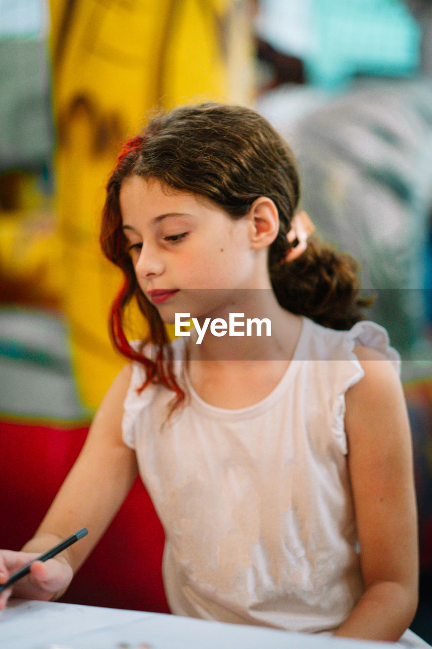 Portrait of cute little girl studying