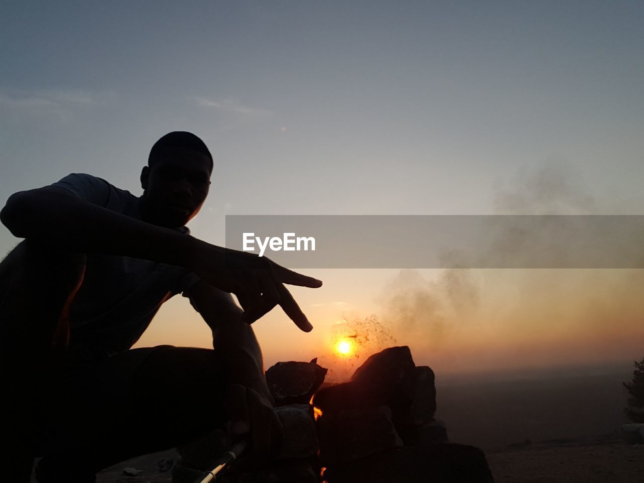 Low angle view of a man against sunset