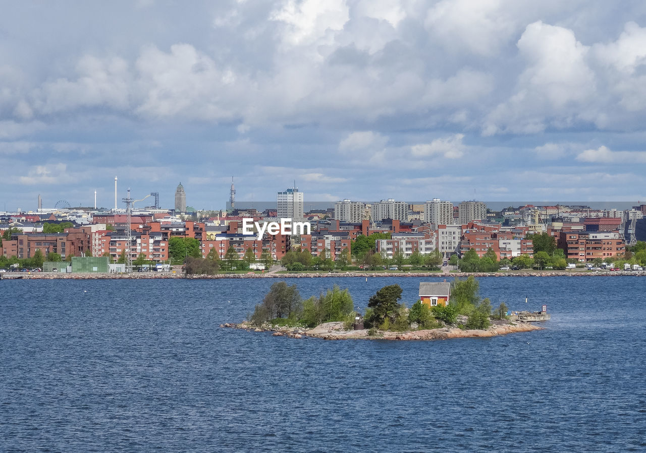 View of cityscape against cloudy sky