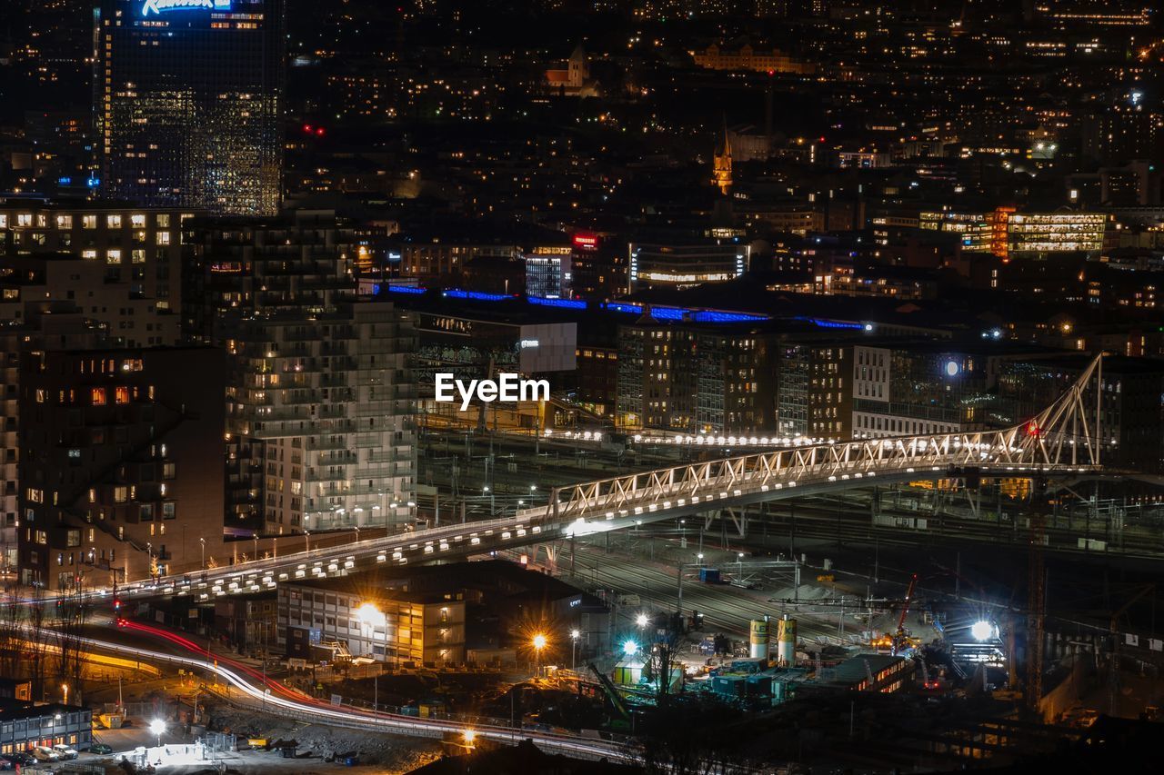 High angle view of illuminated street and buildings at night