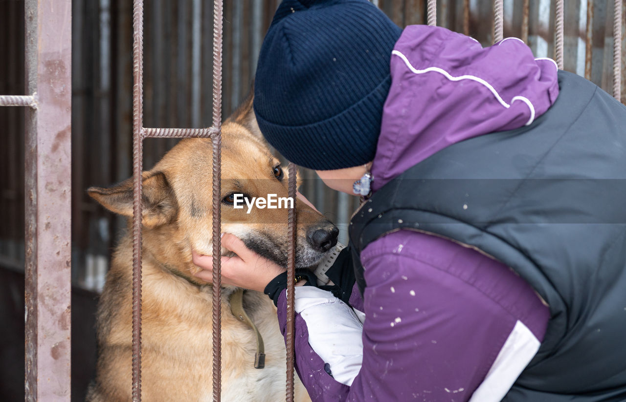 Girl volunteer in the nursery for dogs. shelter for stray dogs.