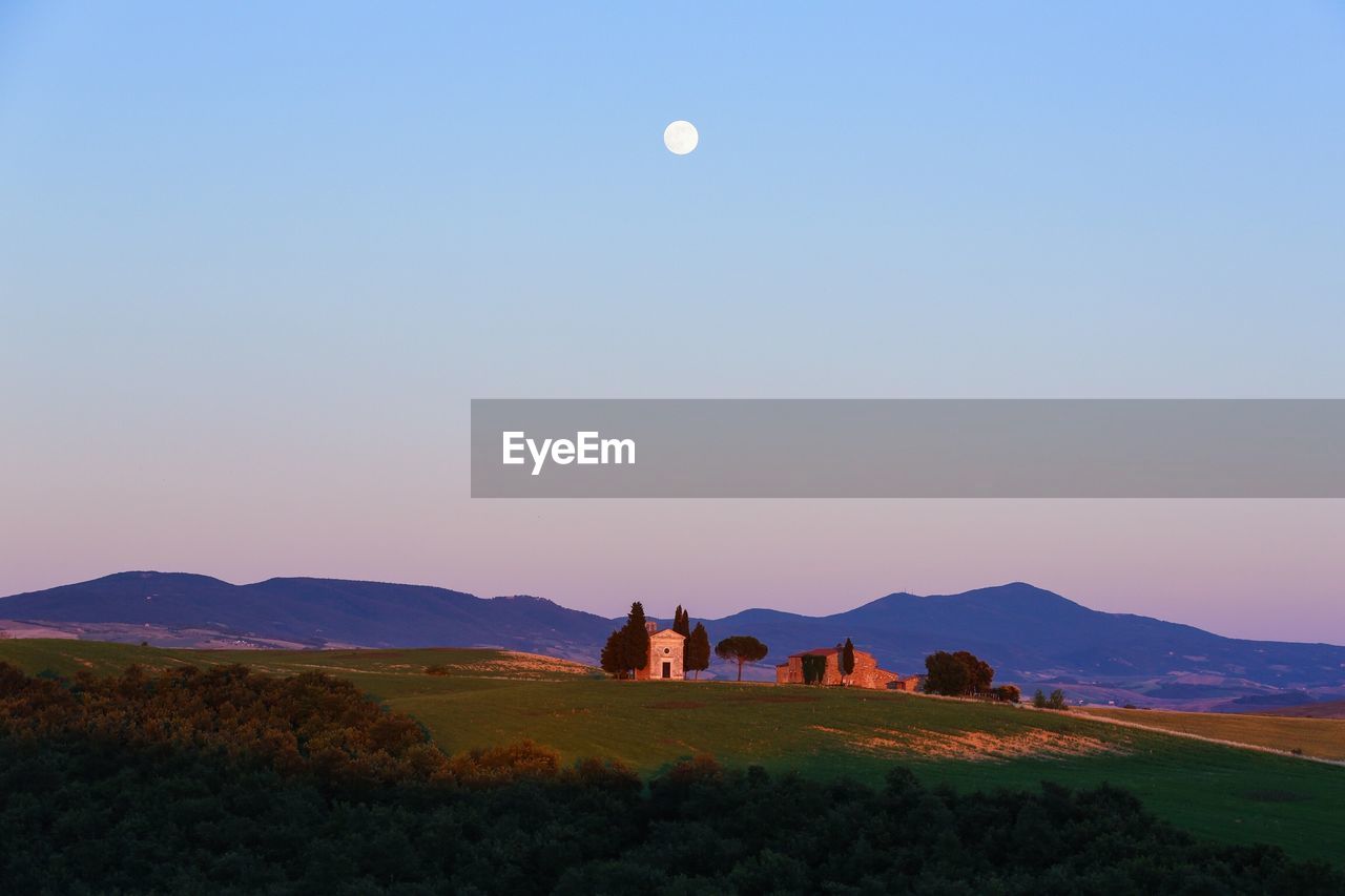 Scenic view of landscape against clear sky during sunset