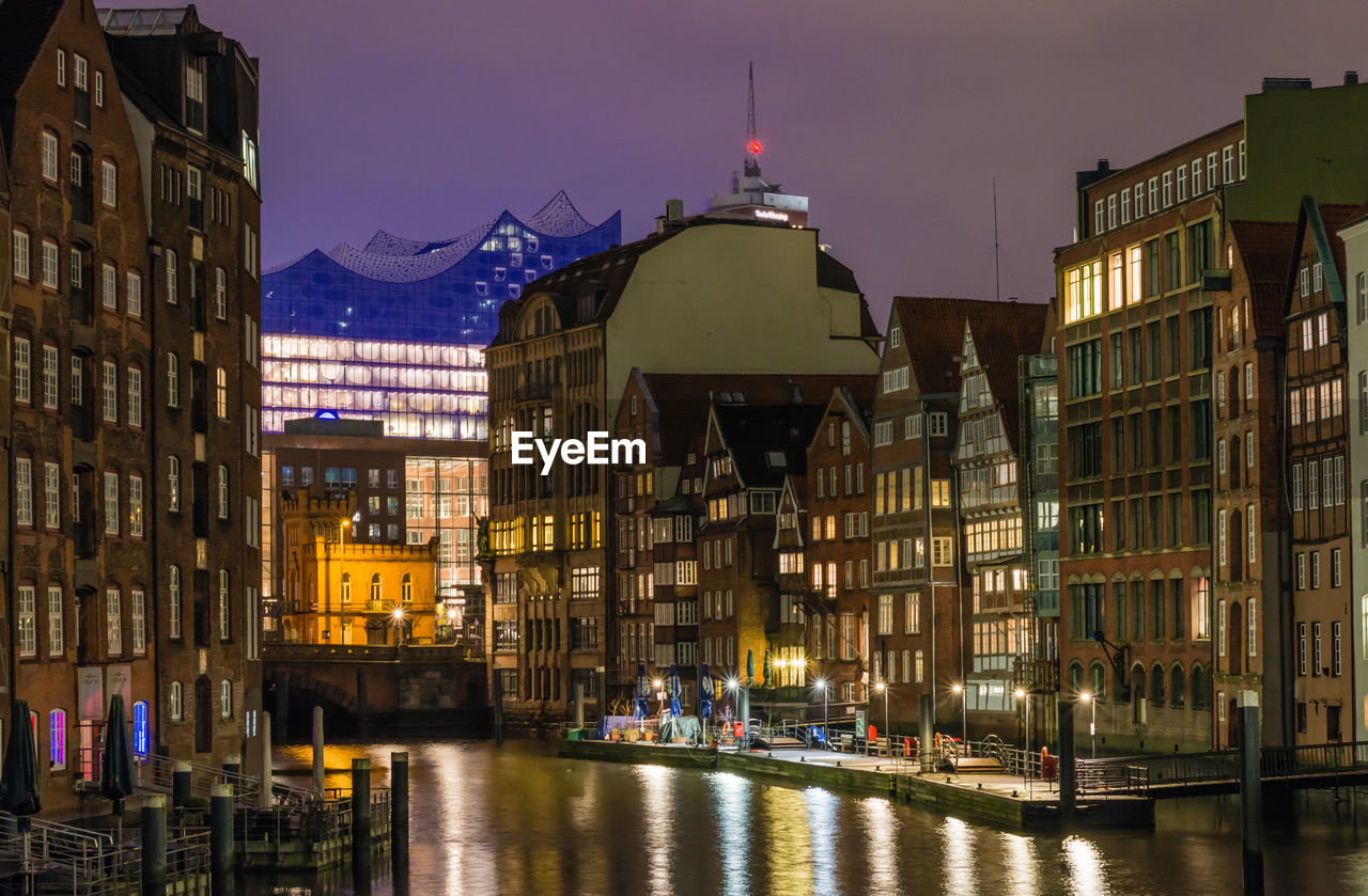 Illuminated view of nikolaifleet canal against sky at night