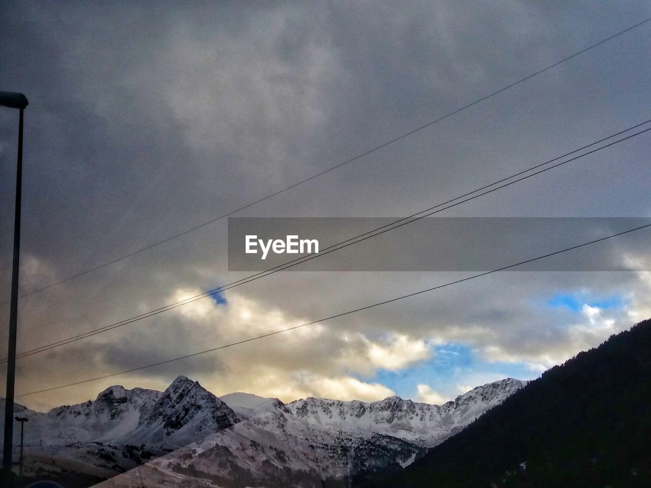 LOW ANGLE VIEW OF MOUNTAIN AGAINST CLOUDY SKY