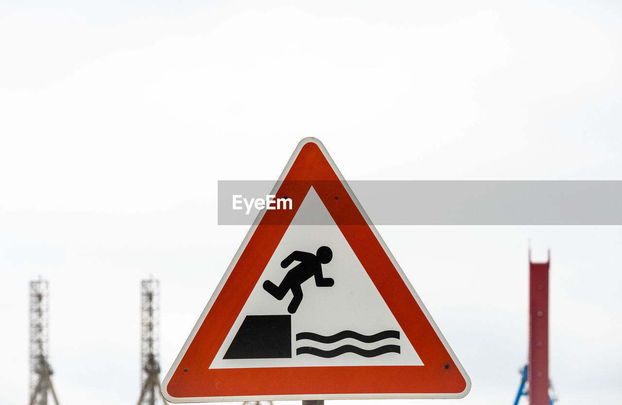 Close-up of road sign against clear sky