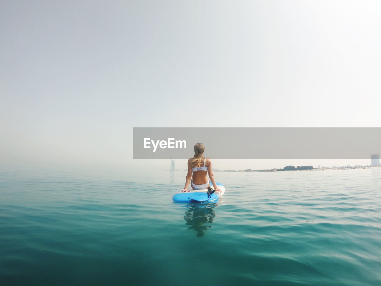 Woman sitting on the paddle board with a view on burj al arab