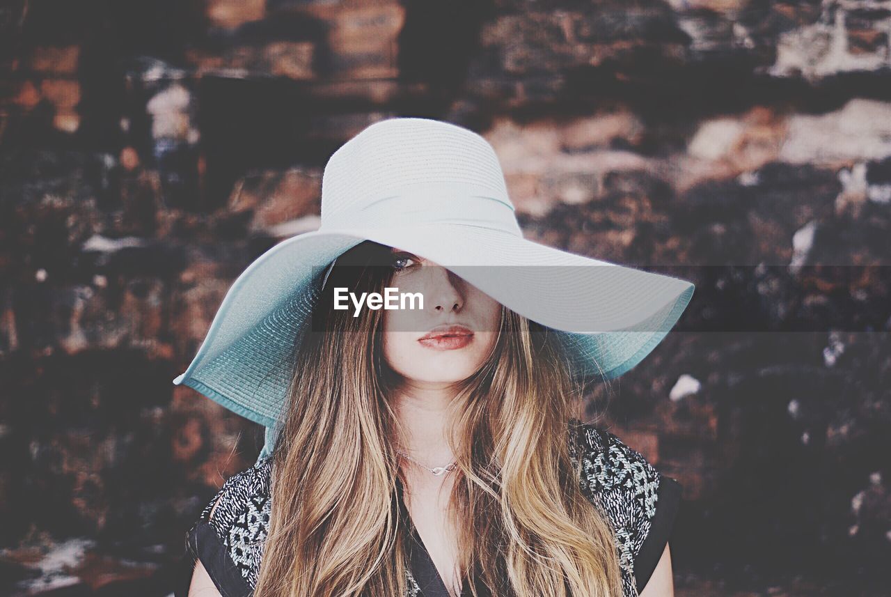 Portrait of beautiful woman wearing sun hat