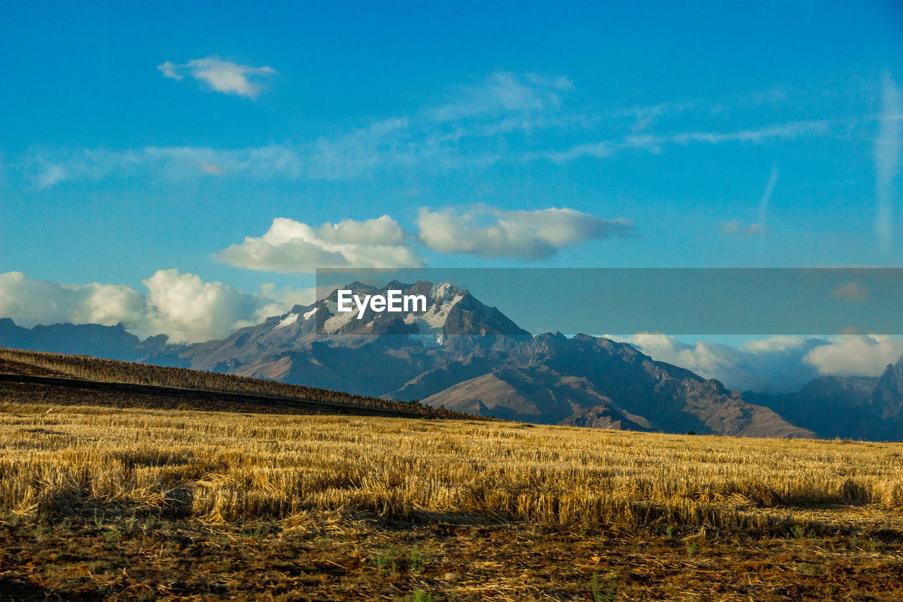 SCENIC VIEW OF FIELD AND MOUNTAINS AGAINST SKY