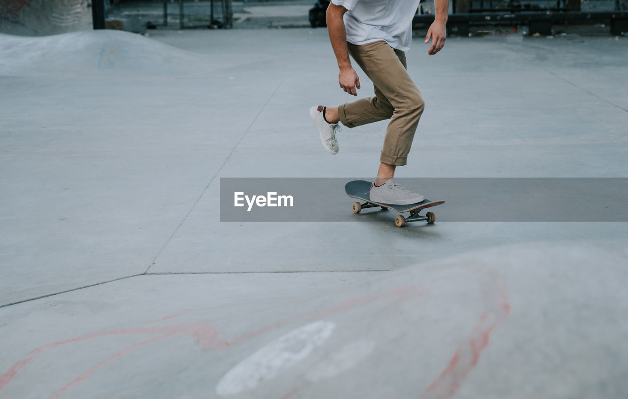 Low section of man skateboarding on skateboard