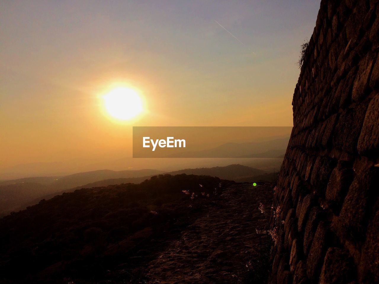 SCENIC VIEW OF MOUNTAINS AGAINST SKY AT SUNSET