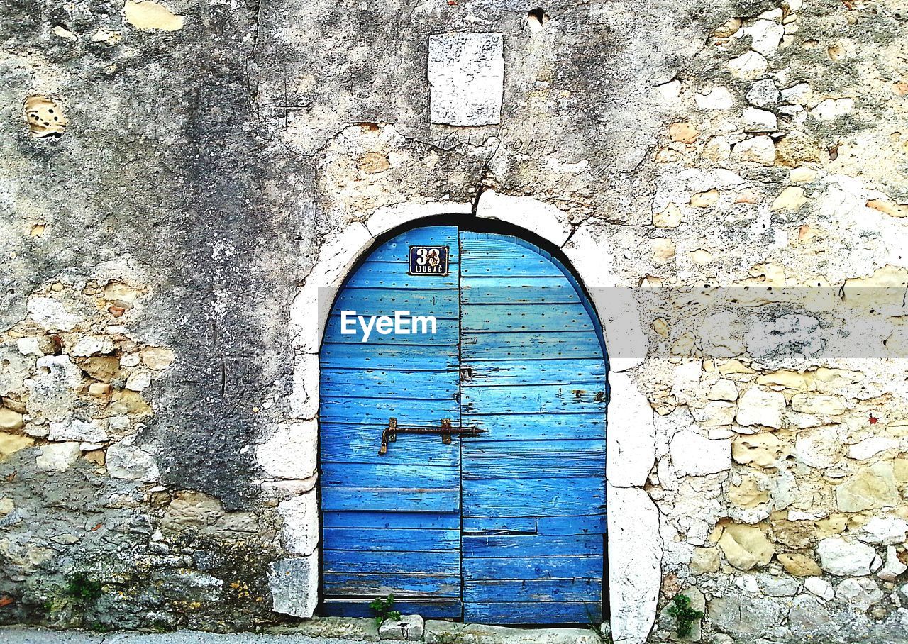 CLOSED DOOR OF BLUE BUILDING