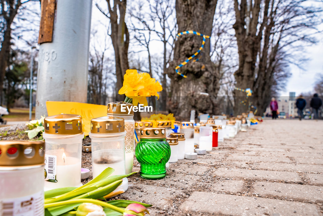 Thousands candles and flowers standing on the street during the war in ukraine