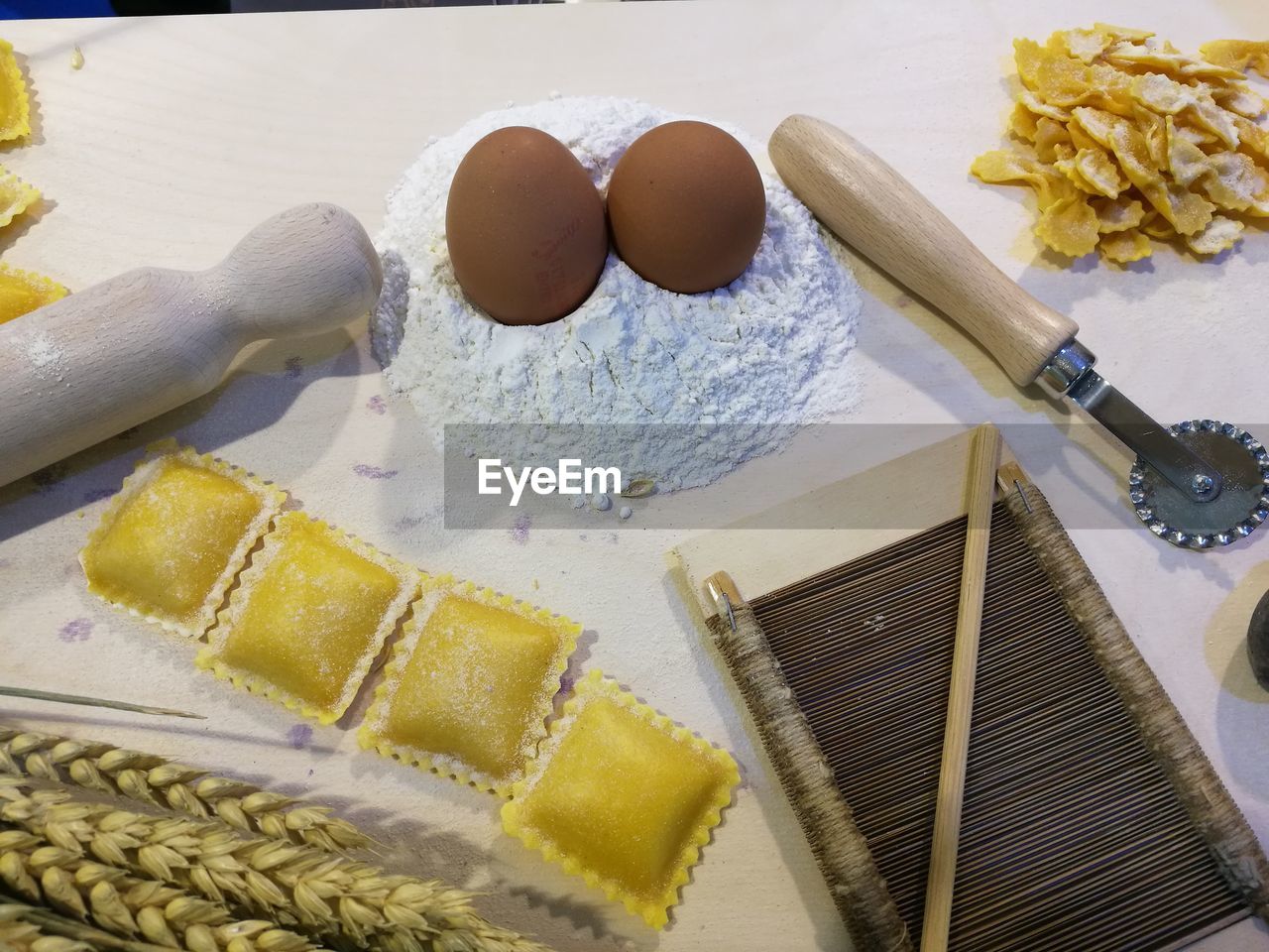 High angle view of ravioli with ingredients on table