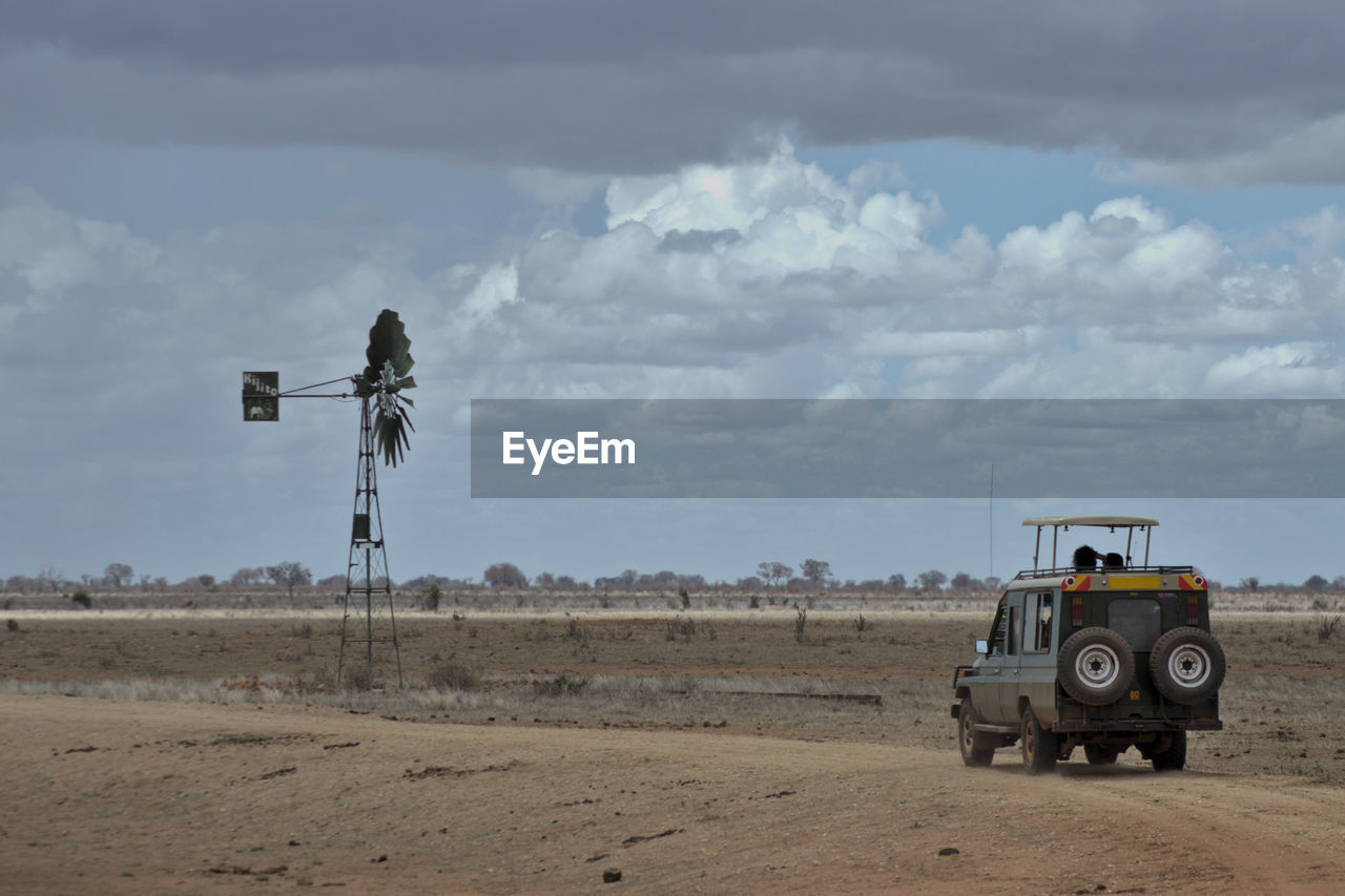 Off road vehicle on field against sky