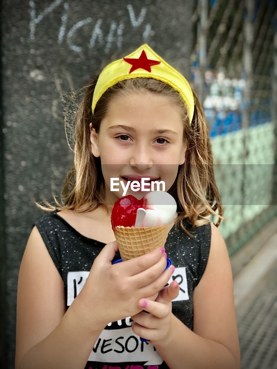 Portrait of girl holding ice cream outdoors