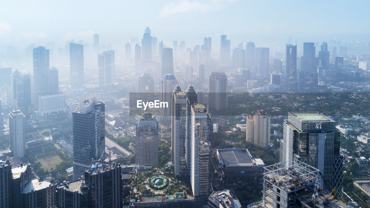 High angle view of modern buildings in city against sky