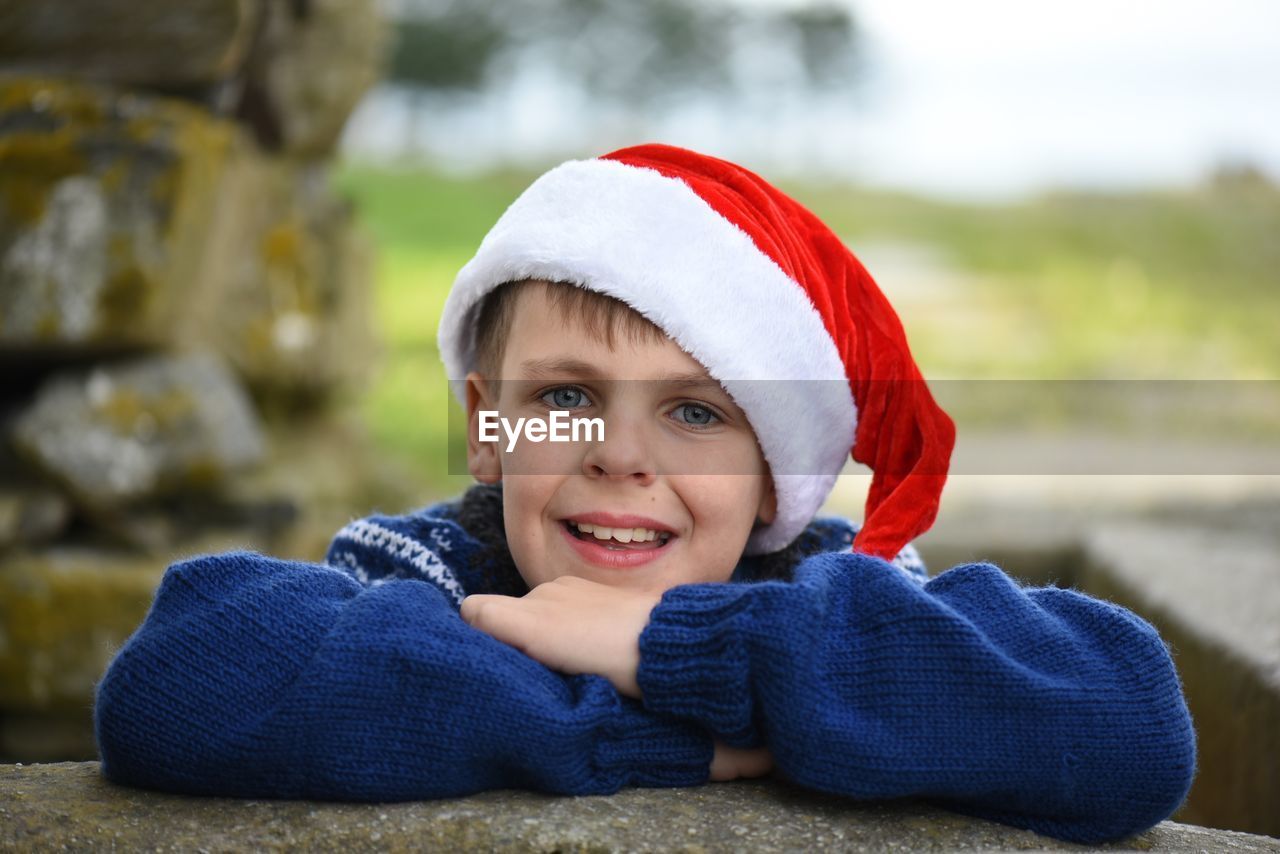 Portrait of boy in santa hat outdoors