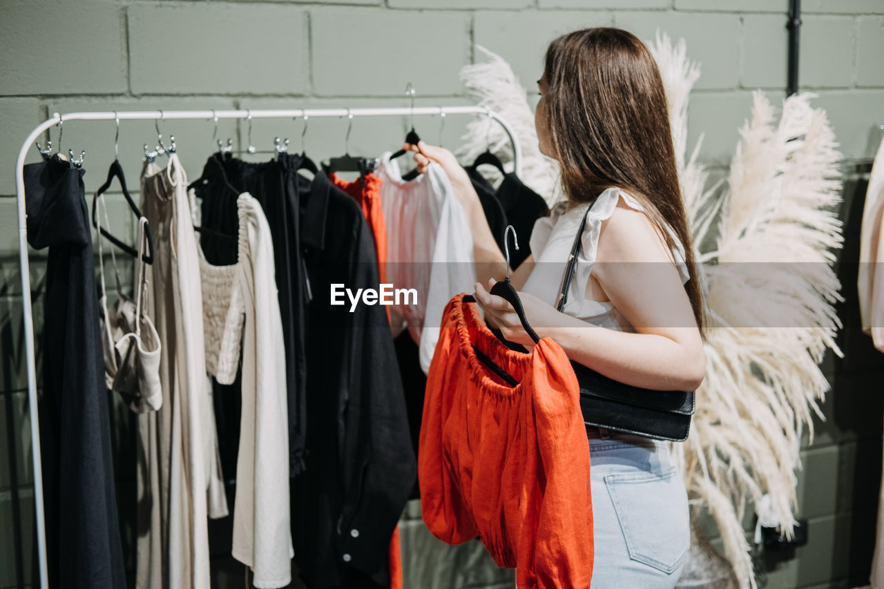 Sustainable fashion, slow fashion, conscious shopping. young latina woman shopping in modern