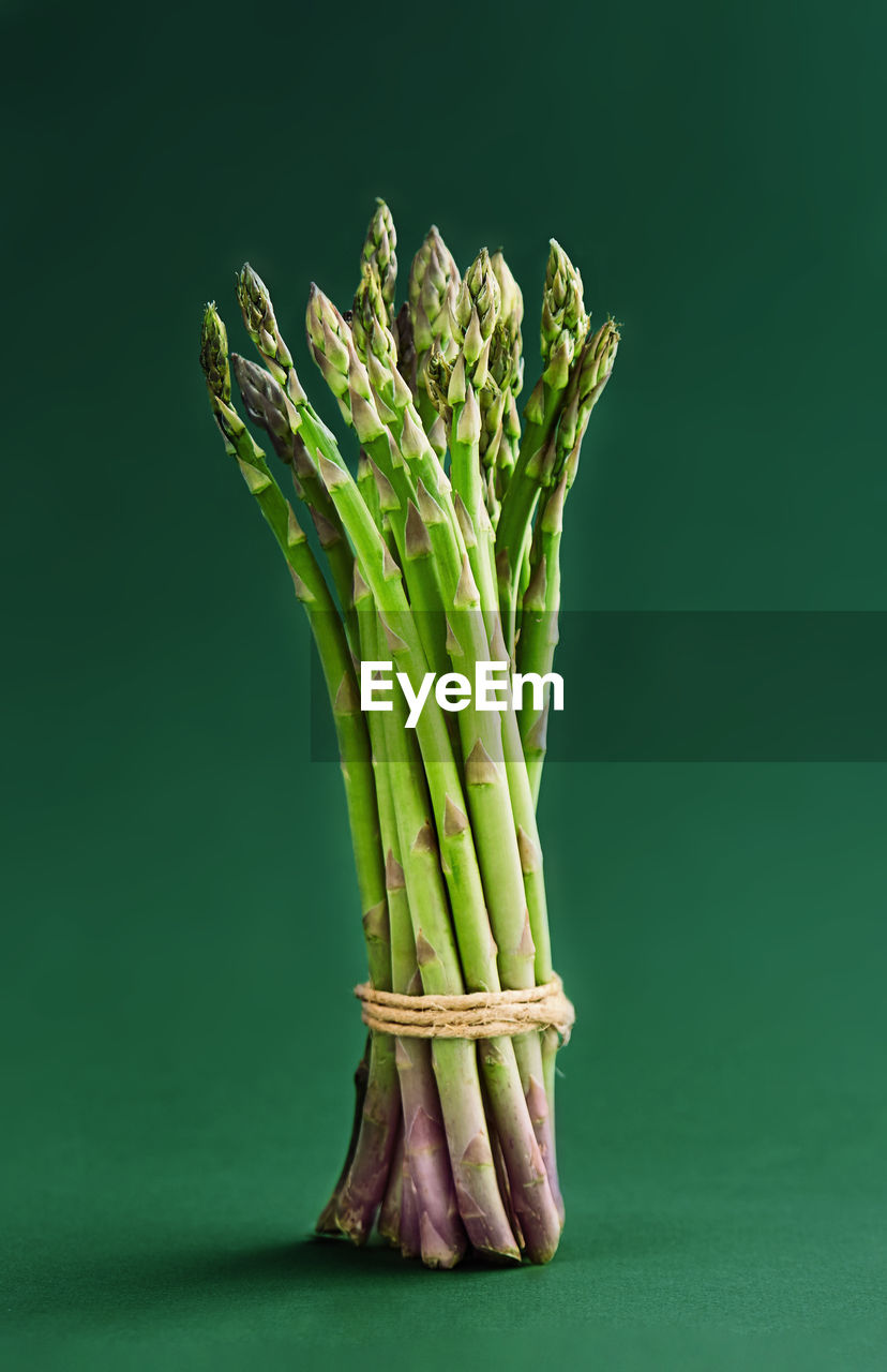 Close-up of asparagus on green background
