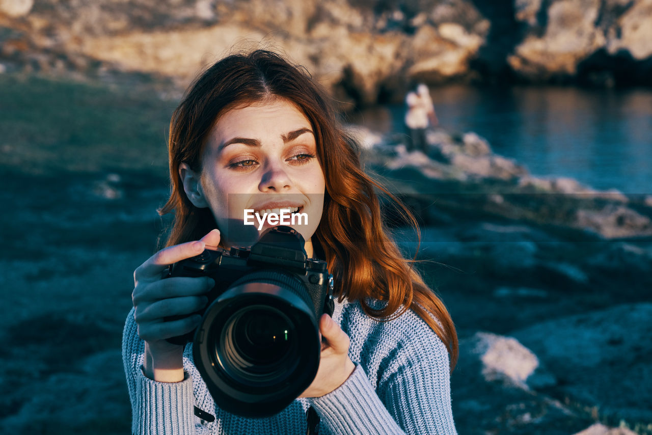 PORTRAIT OF WOMAN PHOTOGRAPHING