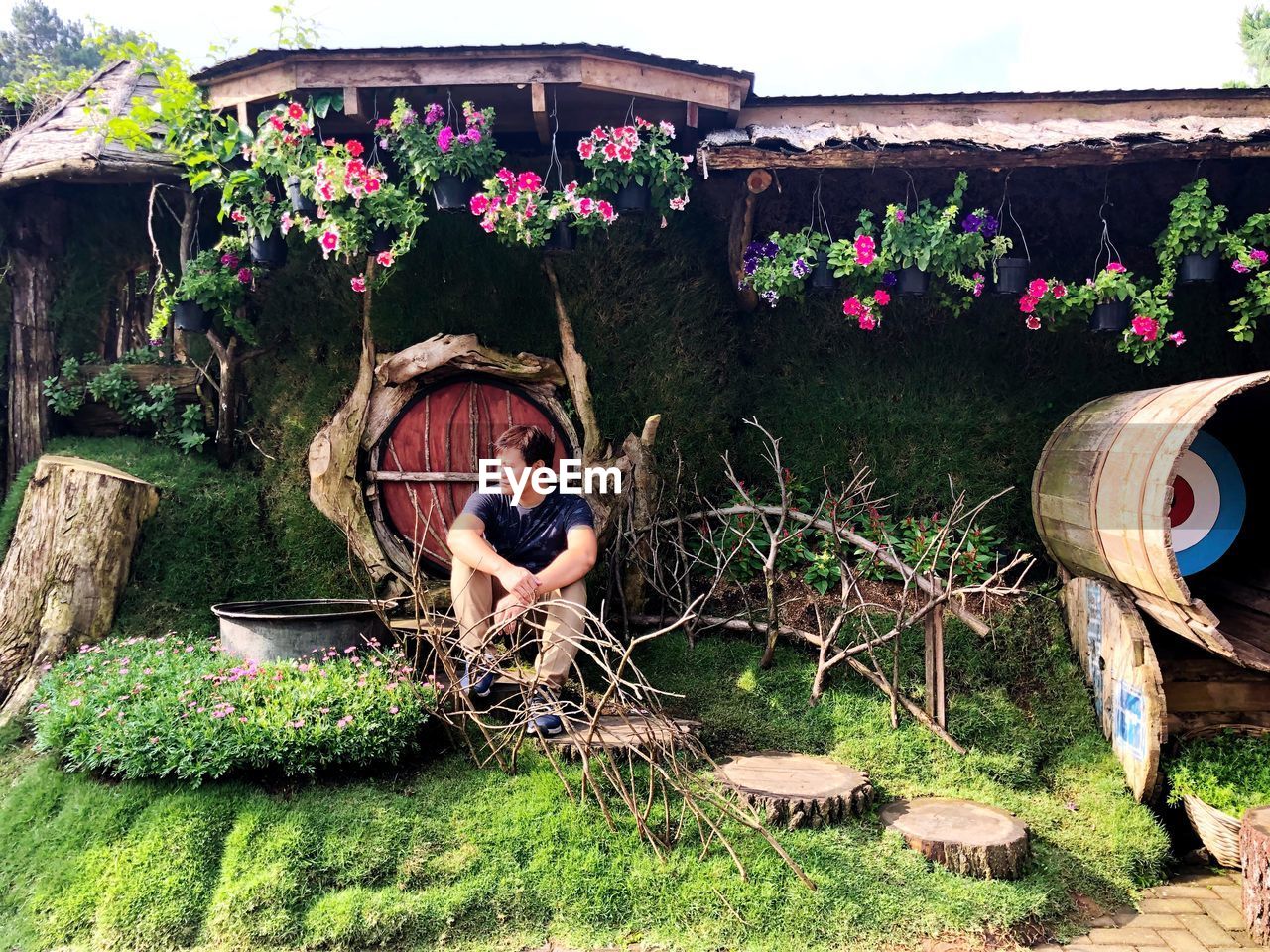 Man sitting against plants